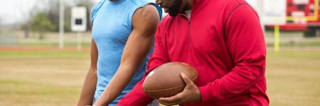 a football coach talking to one of his athletes