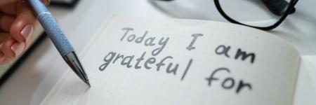 writing in notebook that says "today I am grateful for"